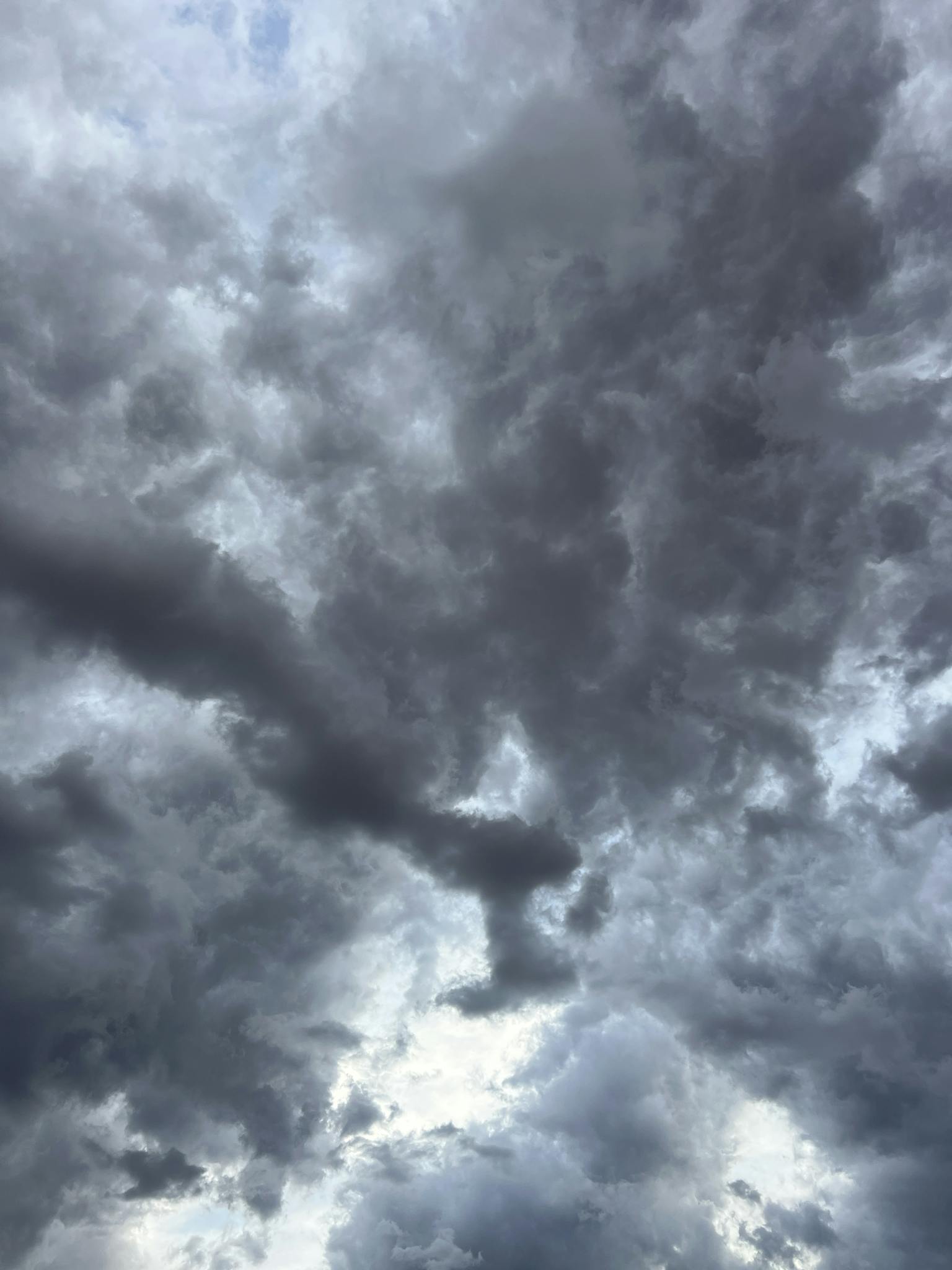 Capture of dark, dramatic clouds forming in a moody, overcast sky, ideal for weather-related themes.
